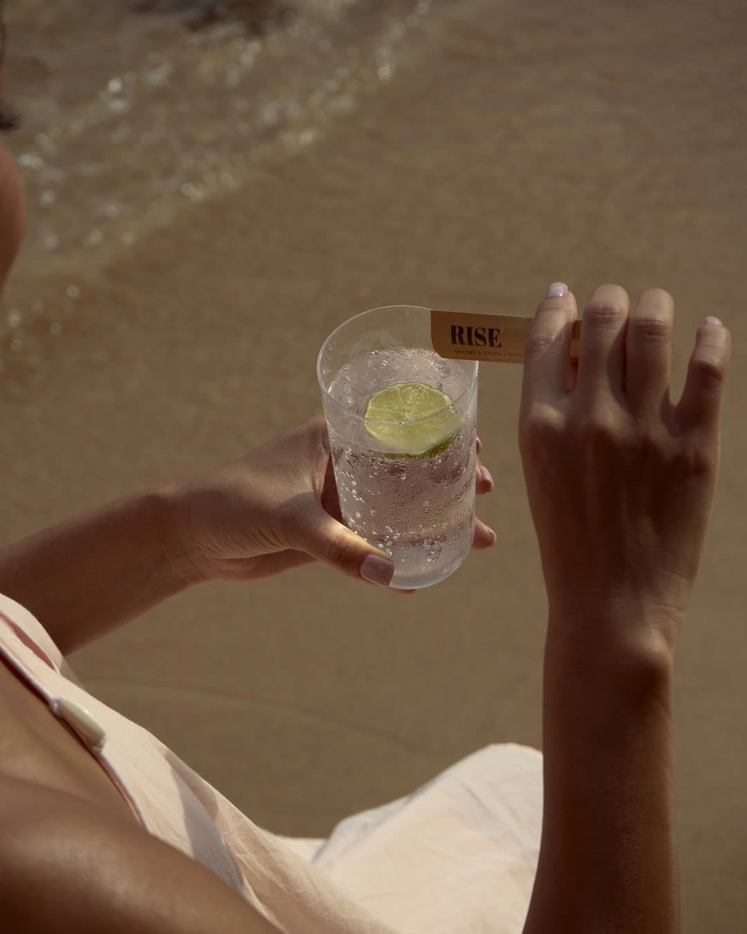 A RISE Daily Dose drink at the beach